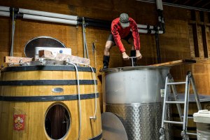 Aaron Pott, a winemaker and wine making consultant, works on pushing down grape skins that had risen to the top during the fermentation process of wine from his own label at Quixote Winery in Napa, Calif., on Friday, September 30, 2016. In addition to consulting there Pott shares space with the winery and produces his own label, Pott Wines, at the location.